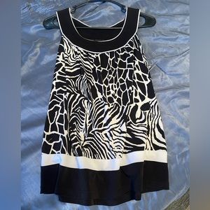 This is a tank top style blouse with a black and white print. Size medium.